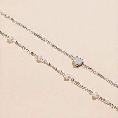 Elegante Dubbel Laags Parels Choker Ketting met Hart Bedel - Perfect Sieraden Geschenk voor Vrouwen